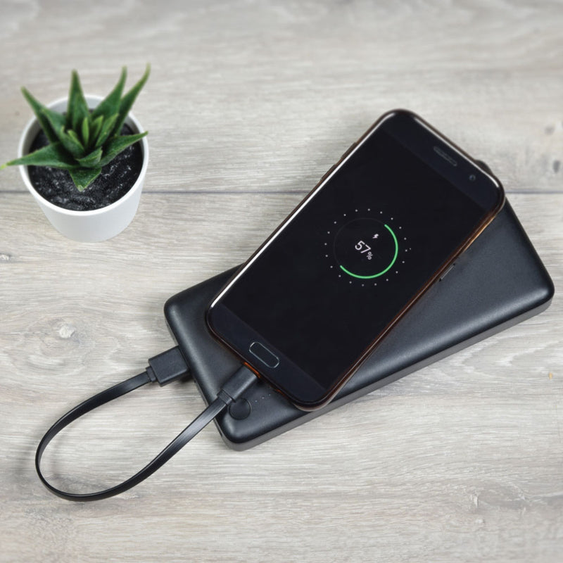 lifestyle image of power back charging a phone via the cable