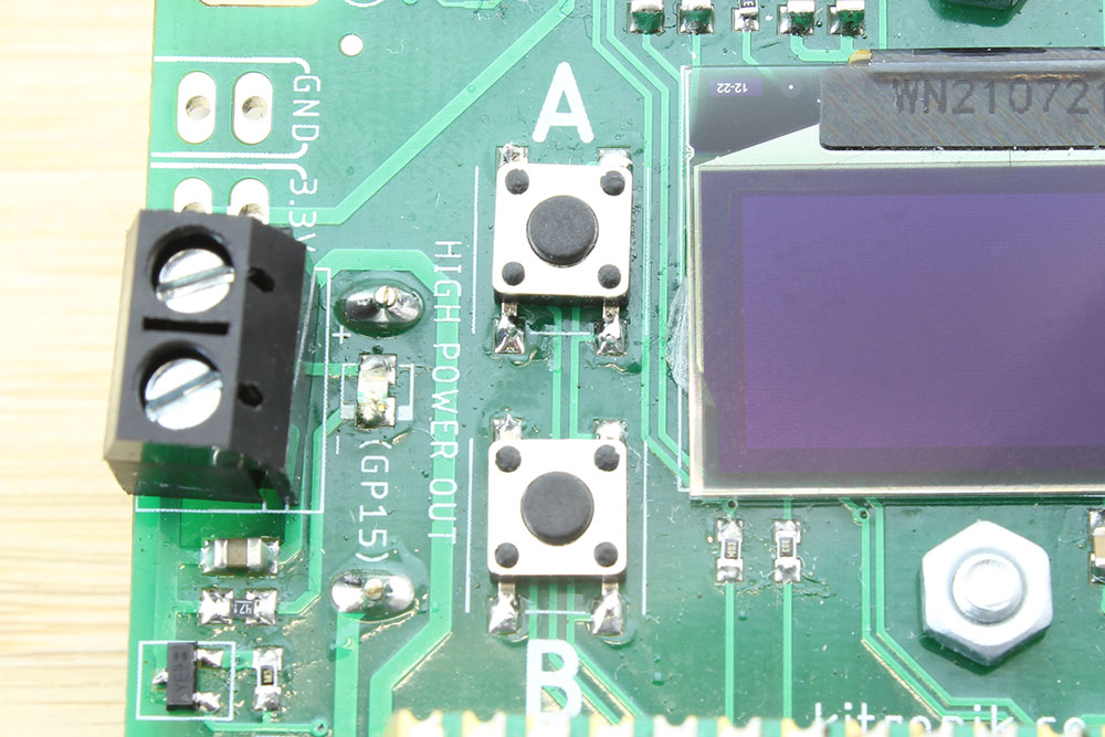 Close up image of buttons A and B on the board